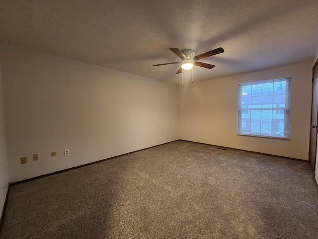 spare room with a textured ceiling, ceiling fan, and carpet floors