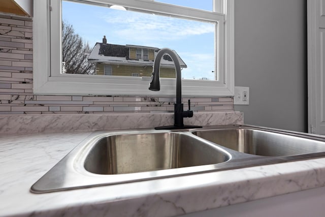 details featuring sink and backsplash