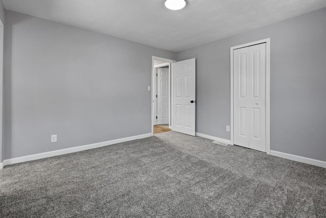 unfurnished bedroom featuring a closet and carpet