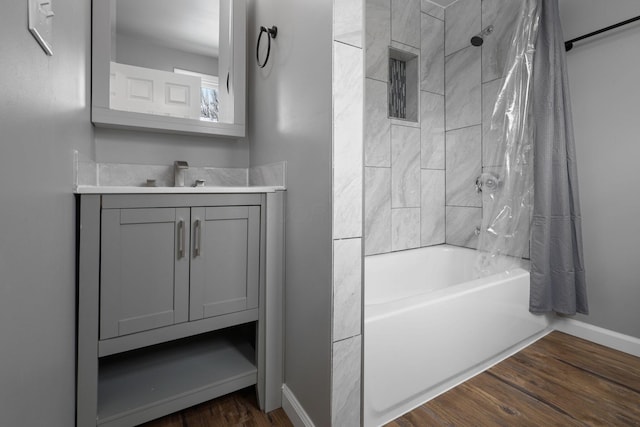 bathroom with shower / tub combo, hardwood / wood-style floors, and vanity