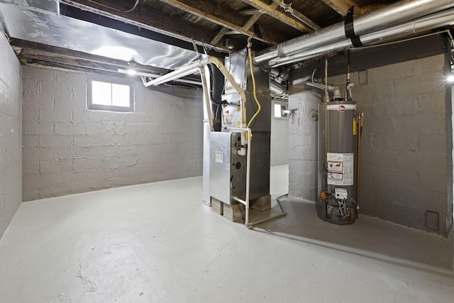 basement with water heater and heating unit