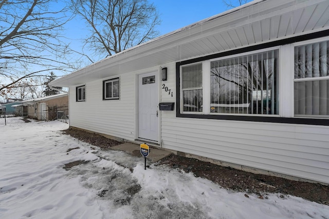 view of snow covered property entrance