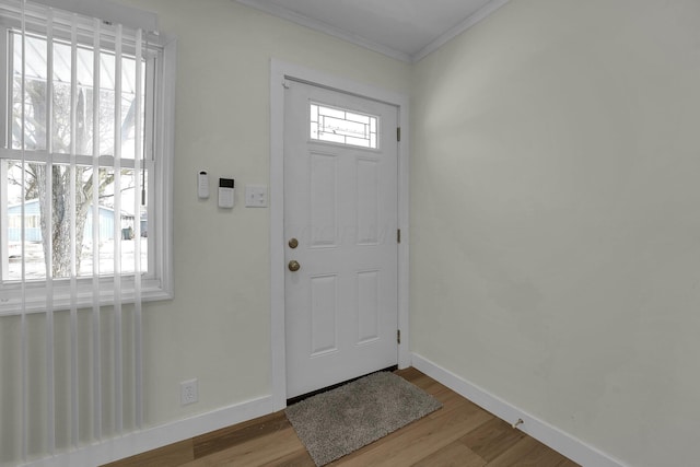 foyer entrance featuring light wood-type flooring and ornamental molding