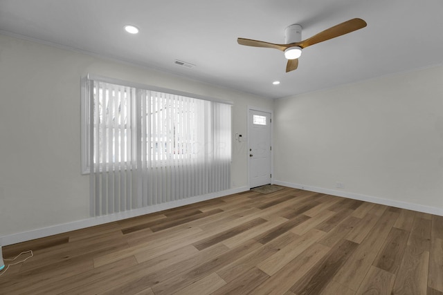 unfurnished room with ceiling fan, wood-type flooring, and ornamental molding