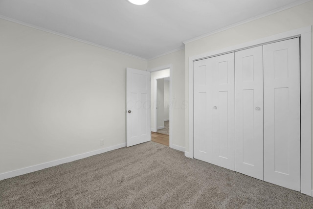 unfurnished bedroom with a closet, crown molding, and carpet flooring