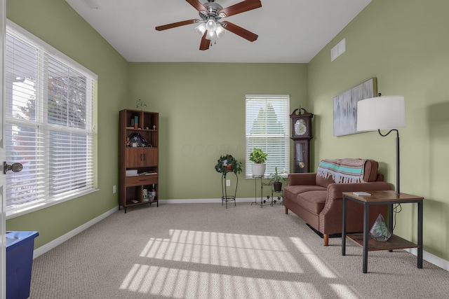 sitting room featuring light carpet and ceiling fan