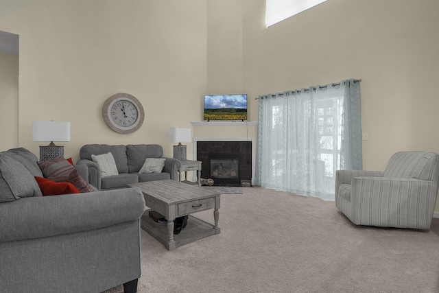 living room featuring a fireplace and light carpet