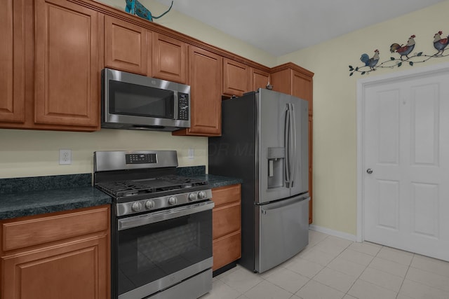 kitchen featuring light tile patterned flooring and stainless steel appliances