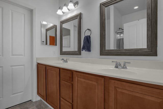 bathroom with vanity and a shower