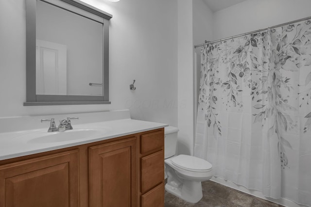 bathroom featuring curtained shower, toilet, and vanity