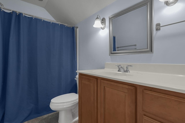 bathroom with toilet, tile patterned floors, lofted ceiling, and vanity