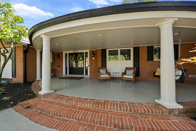 view of exterior entry featuring a porch