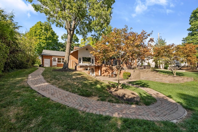 rear view of house featuring a lawn and a garage