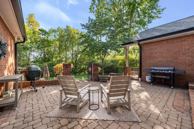 view of patio / terrace featuring a fire pit and grilling area