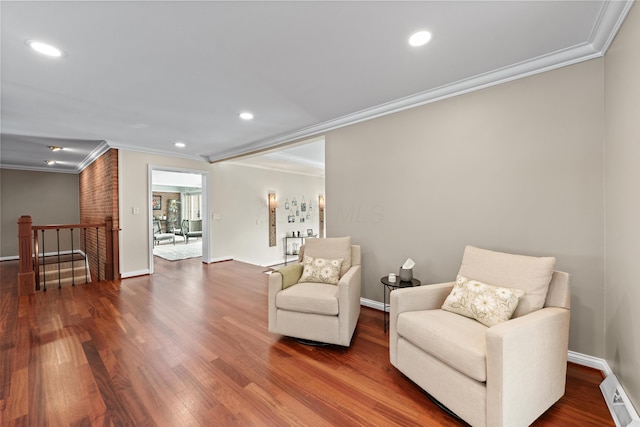 sitting room with wood-type flooring and crown molding