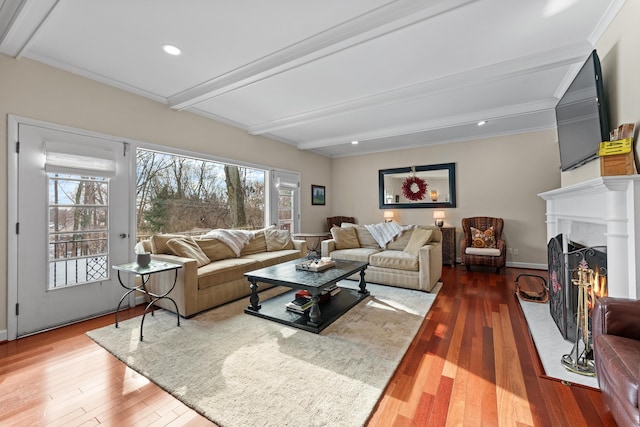 living room with hardwood / wood-style floors, ornamental molding, and beamed ceiling