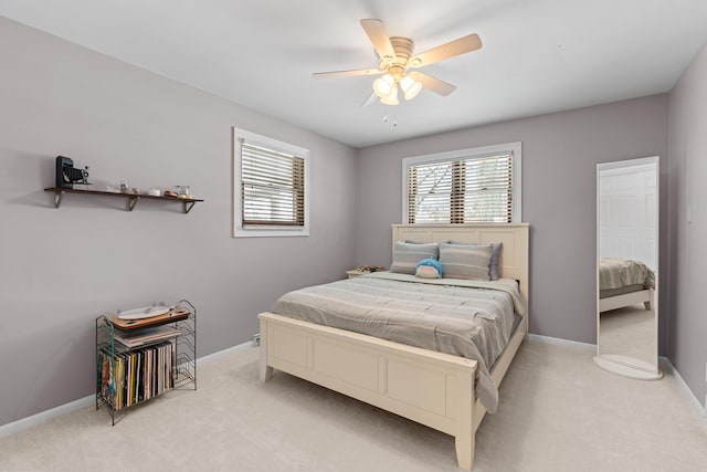 bedroom featuring ceiling fan and light carpet