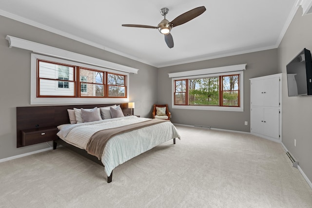 carpeted bedroom with ceiling fan, ornamental molding, and multiple windows