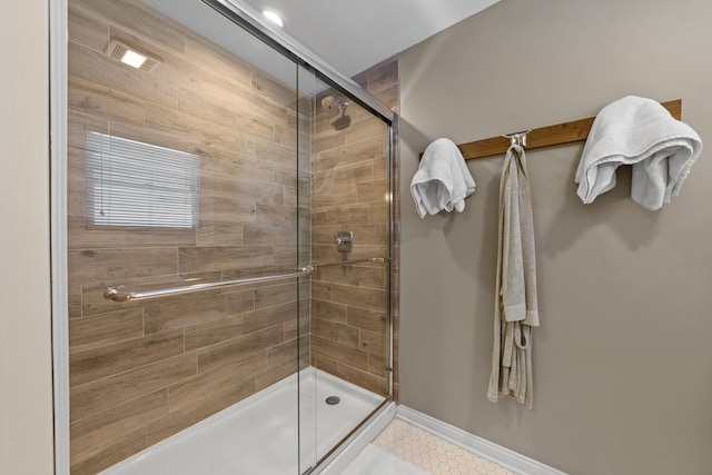 bathroom featuring a shower with door