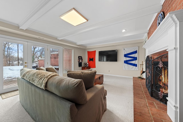 living room with a brick fireplace, beamed ceiling, and french doors