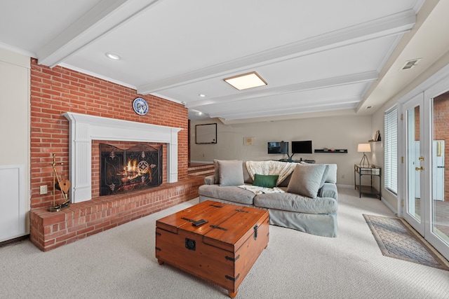 carpeted living room featuring a brick fireplace and beamed ceiling