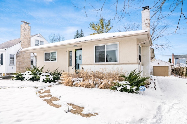 view of front of home featuring a garage and an outdoor structure