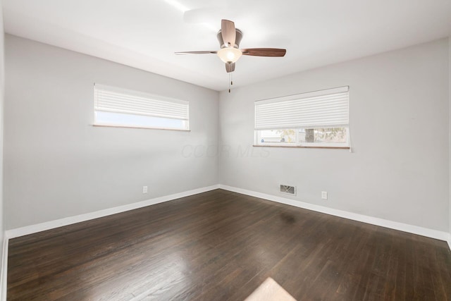 spare room featuring ceiling fan and dark hardwood / wood-style flooring