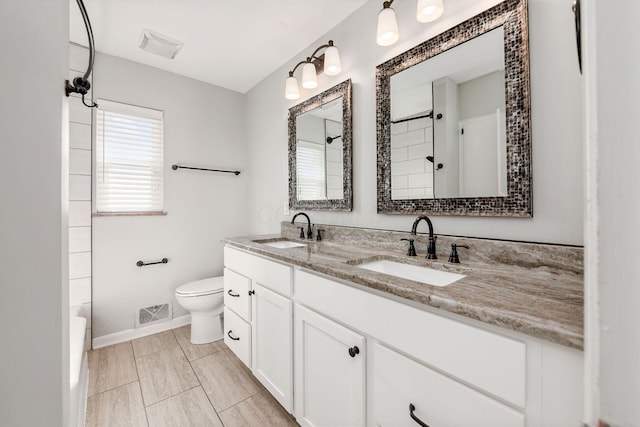 full bathroom with toilet, vanity, and shower / tub combination