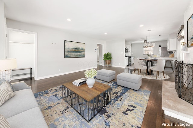 living room featuring ceiling fan and dark hardwood / wood-style flooring