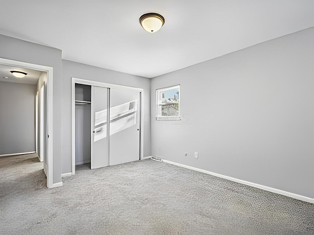 unfurnished bedroom featuring a closet and carpet flooring