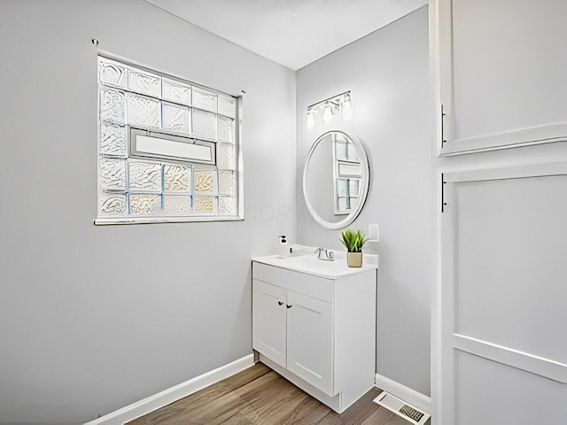 bathroom with hardwood / wood-style flooring and vanity