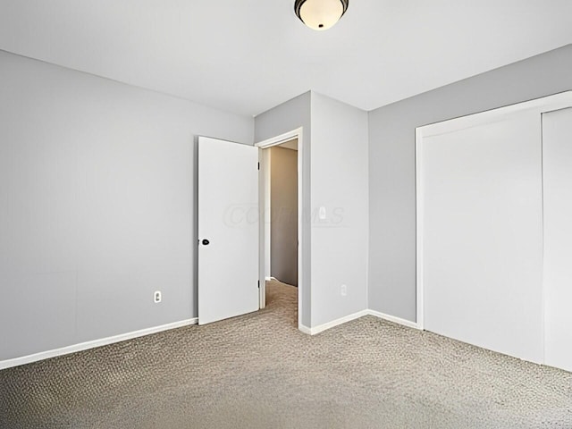 unfurnished bedroom featuring a closet and carpet flooring