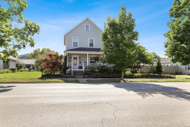 view of front of home with a porch and a front yard