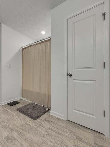 bathroom featuring baseboards and a textured ceiling