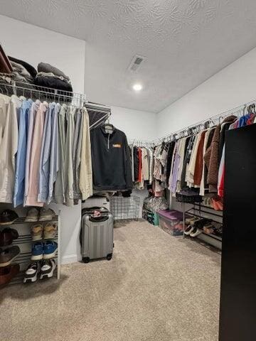 spacious closet featuring carpet flooring and visible vents