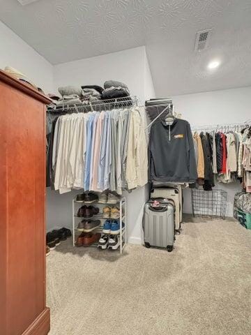 walk in closet with carpet floors and visible vents