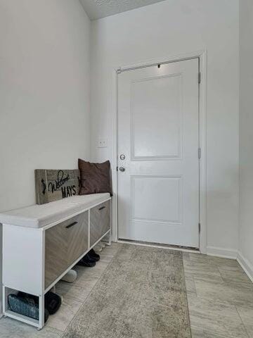 mudroom featuring a textured ceiling