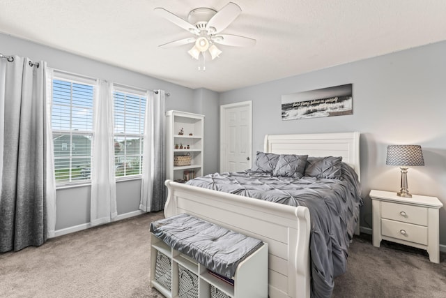 carpeted bedroom featuring ceiling fan and multiple windows