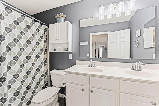 bathroom featuring curtained shower, a textured ceiling, toilet, and vanity