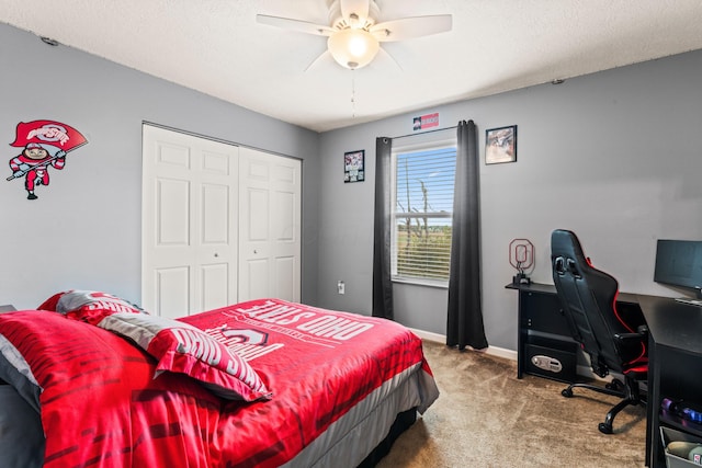 carpeted bedroom with a textured ceiling, a closet, and ceiling fan