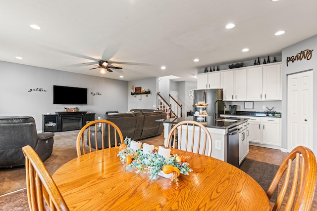 dining area with ceiling fan and sink