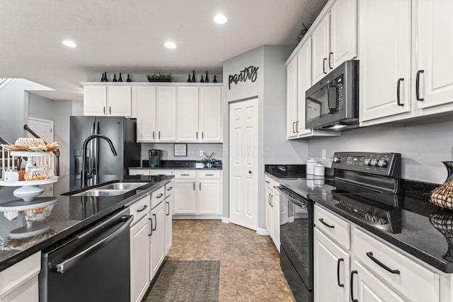 kitchen featuring black appliances, dark stone countertops, white cabinets, and sink