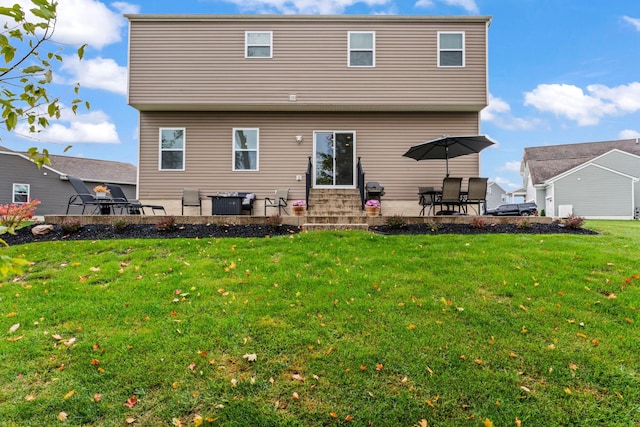 back of property with a patio area and a yard