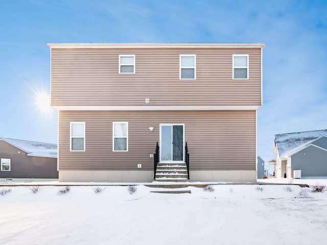 view of snow covered back of property