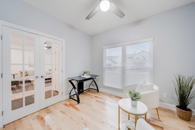 sitting room with french doors, ceiling fan, and light wood-type flooring