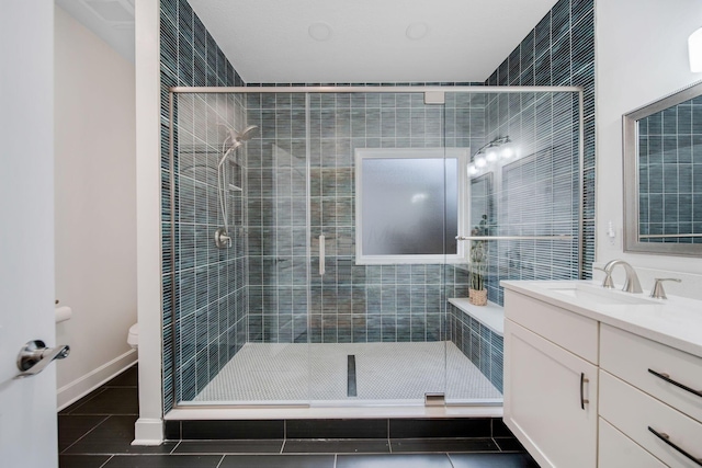 bathroom with tile patterned flooring, vanity, a shower with door, and toilet