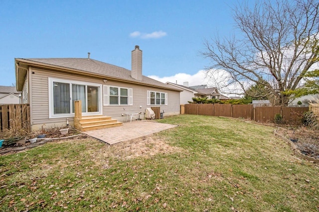 rear view of house with a yard and a patio