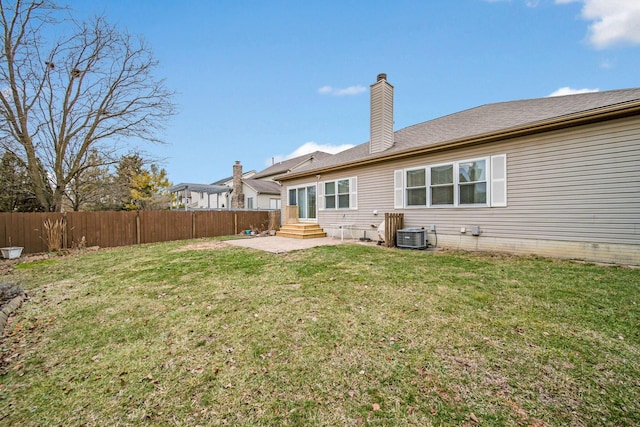 rear view of property featuring a yard, a patio area, and central air condition unit