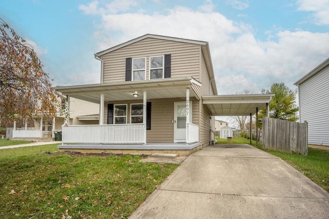 view of front of property featuring covered porch, a storage unit, a front lawn, and a carport