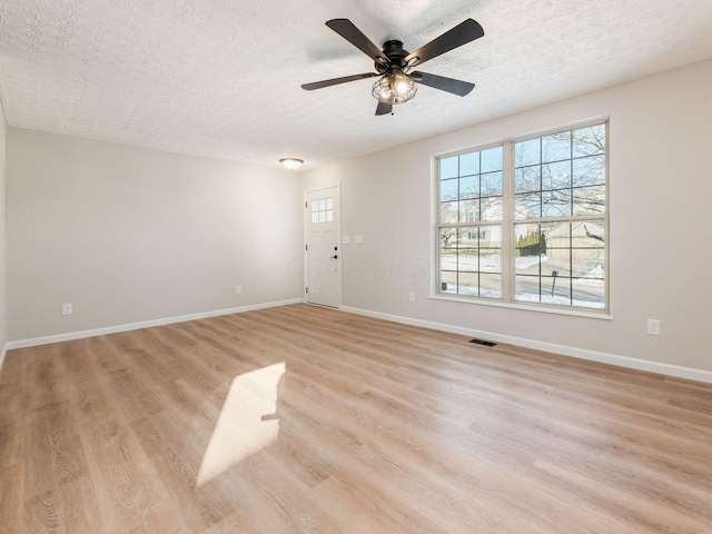 interior space with light hardwood / wood-style floors, a textured ceiling, and ceiling fan